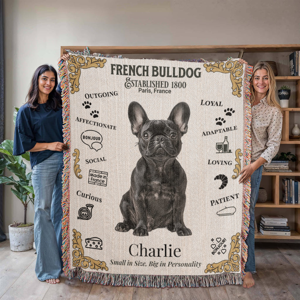 Two women holding a French Bulldog-themed blanket with illustrations and text.Personalized with your Frenchie's Name and photo,