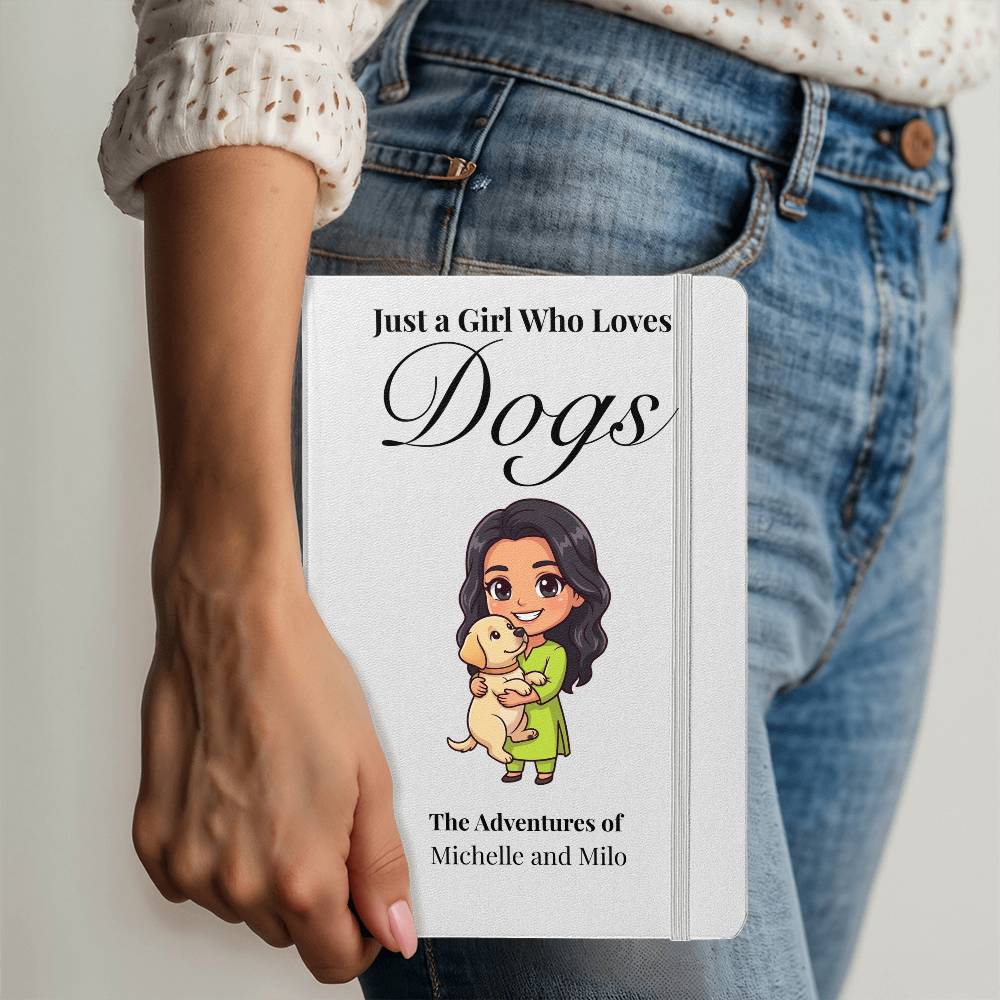 Person holding a notebook with 'Just a Girl Who Loves Dogs' design