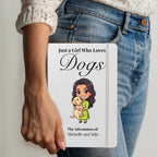 Person holding a notebook with 'Just a Girl Who Loves Dogs' design