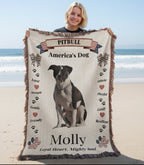 Woman holding a blanket with a pitbull design and text outdoors. Personalize your favorite picture of your Pitte on this custom woven blanket with their name.
