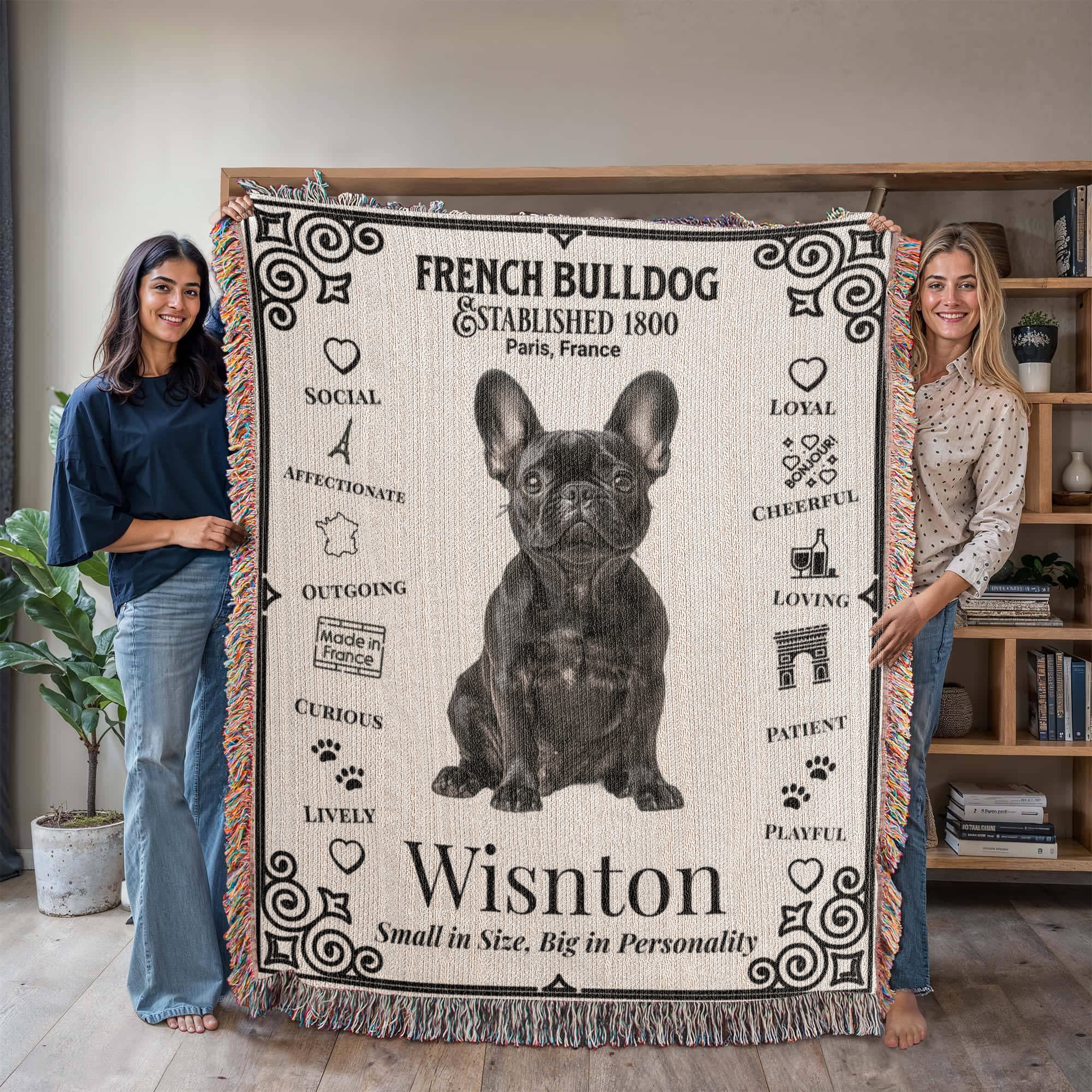 Two people holding a French Bulldog-themed blanket with text and graphics.Personalized with your Frenchie's photo and name.