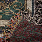 Close-up of a textured blanket with fringes in various colors.