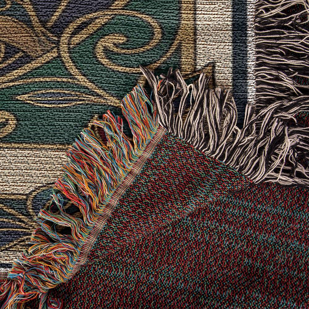 Close-up of a textured blanket with fringes in various colors.