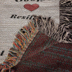 woven blanket Textile with fringes and a heart design on a textured background