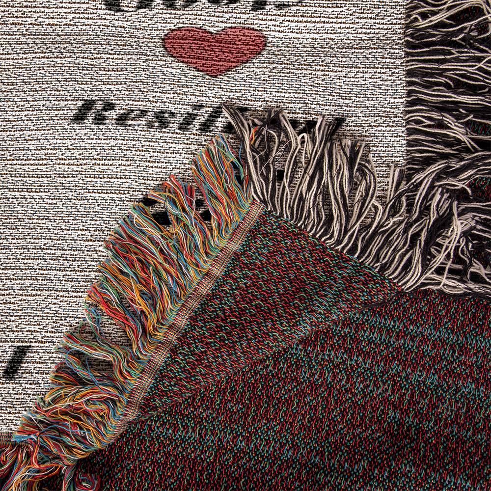 woven blanket Textile with fringes and a heart design on a textured background