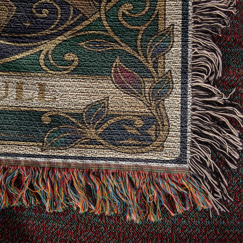Close-up of a woven blanket, textured fabric with intricate patterns and fringes.