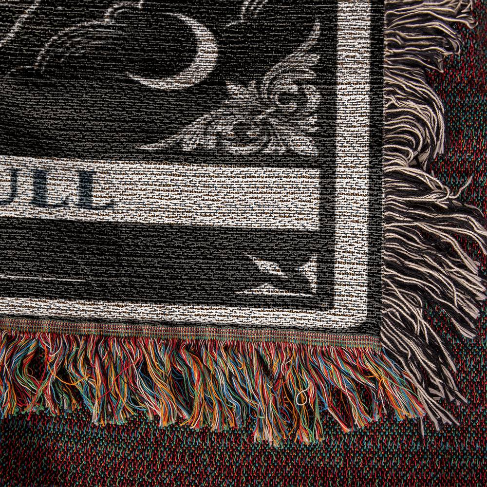 Close-up of a woven blanket, textured fabric with fringes and intricate patterns
