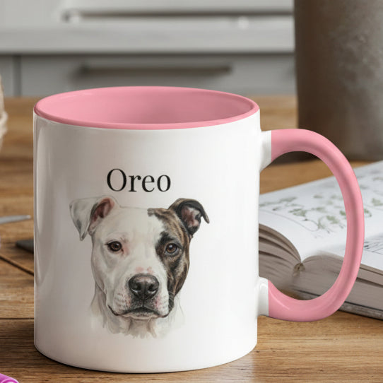 White mug with pink interior and handle featuring a dog's face and name 'Oreo' on a wooden table.
