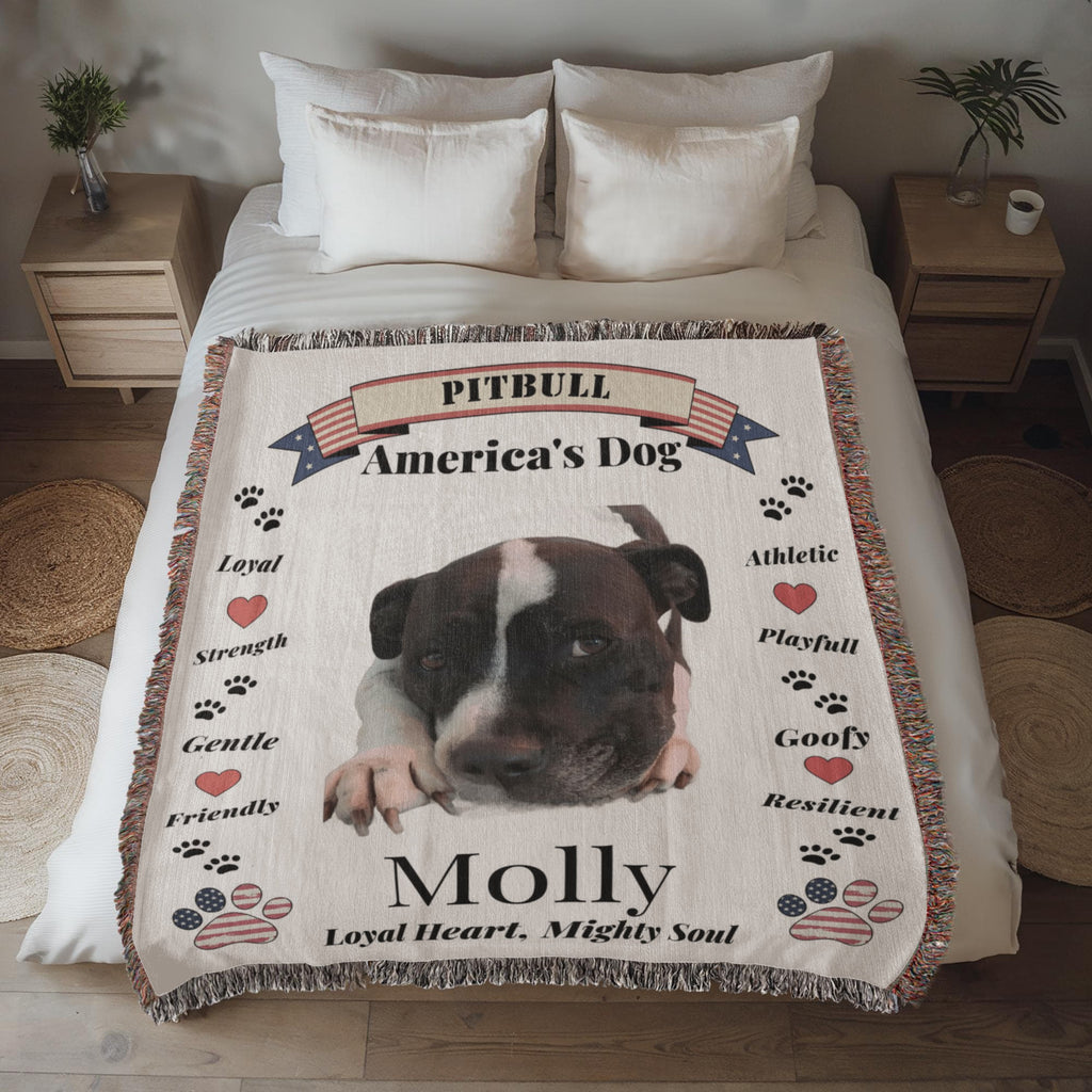 Pitbull-themed blanket with text on a bed in a bedroom setting. Personalize your favorite picture of your Pitte on this custom woven blanket with their name.