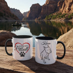 Two mugs with dog-themed designs on a wooden surface with a scenic background of a lake and mountains.