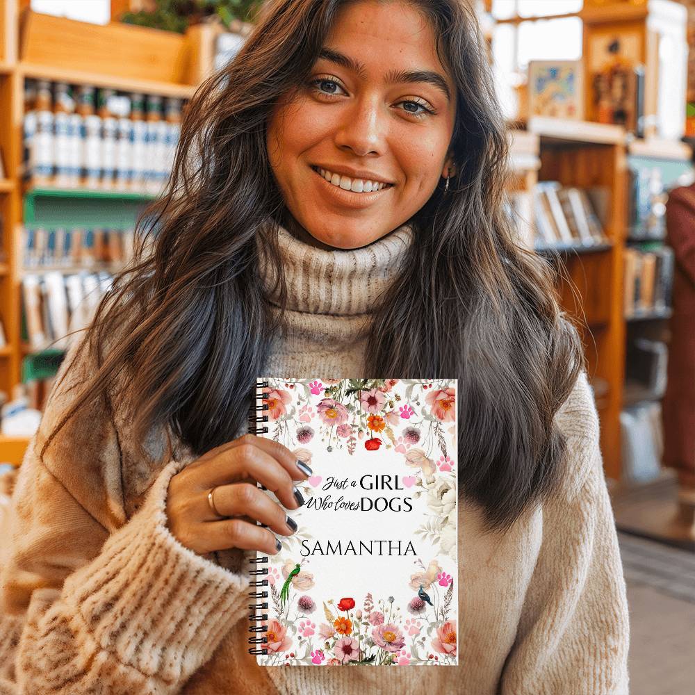 Woman holding a notebook with floral design and text in a bookstore