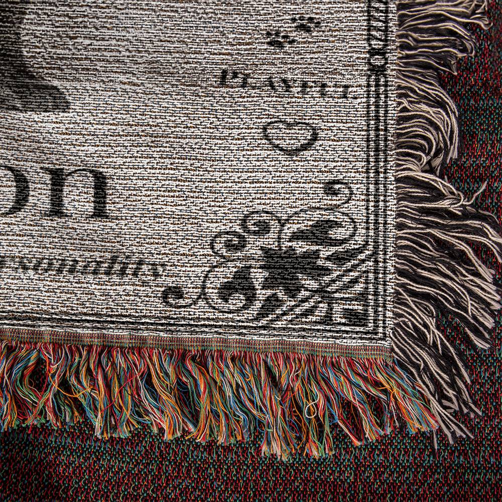 Close-up of a textured fabric with fringes and printed text