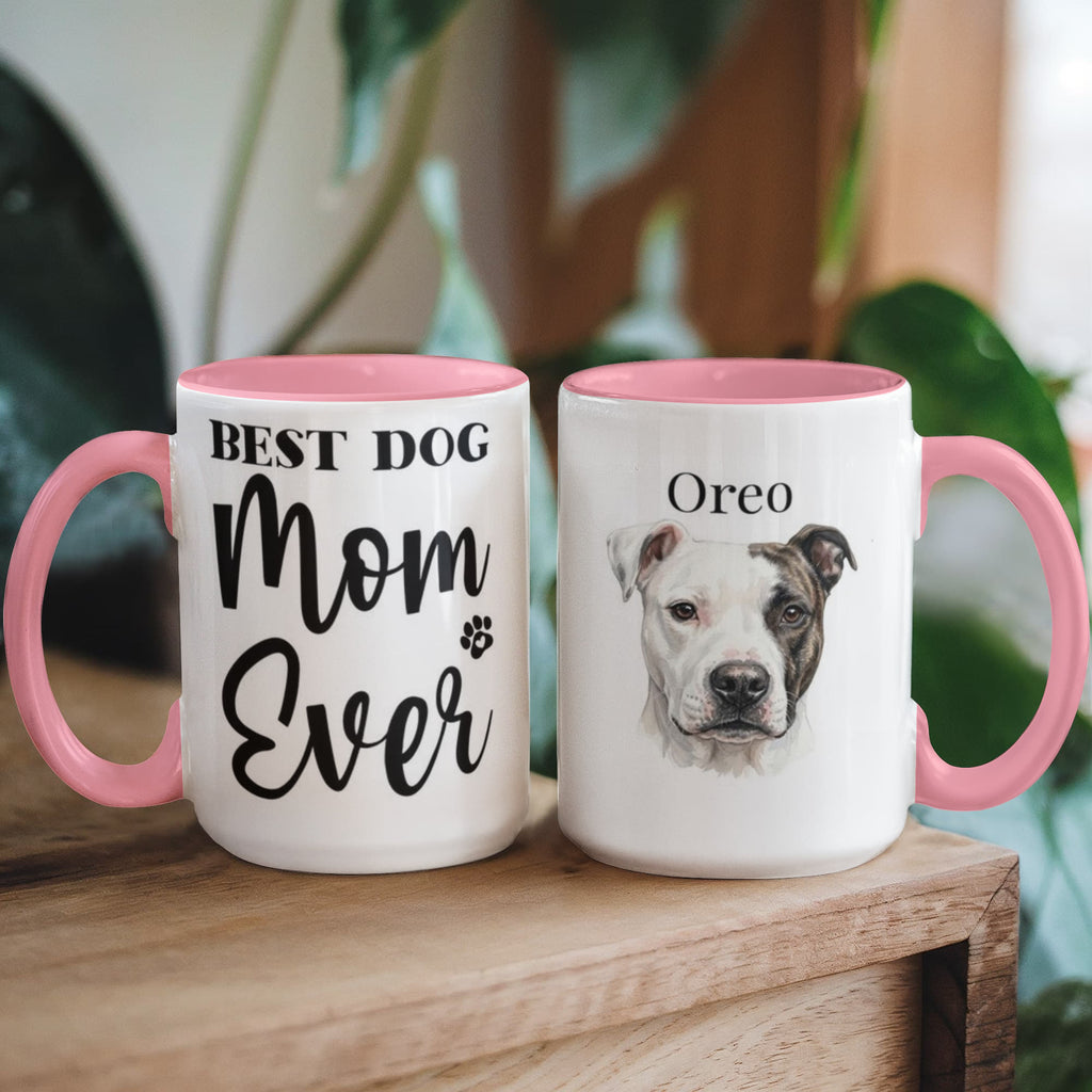 Two mugs with pink handles; one reads 'Best Dog Mom Ever' and the other has a dog's face and name 'Oreo'.