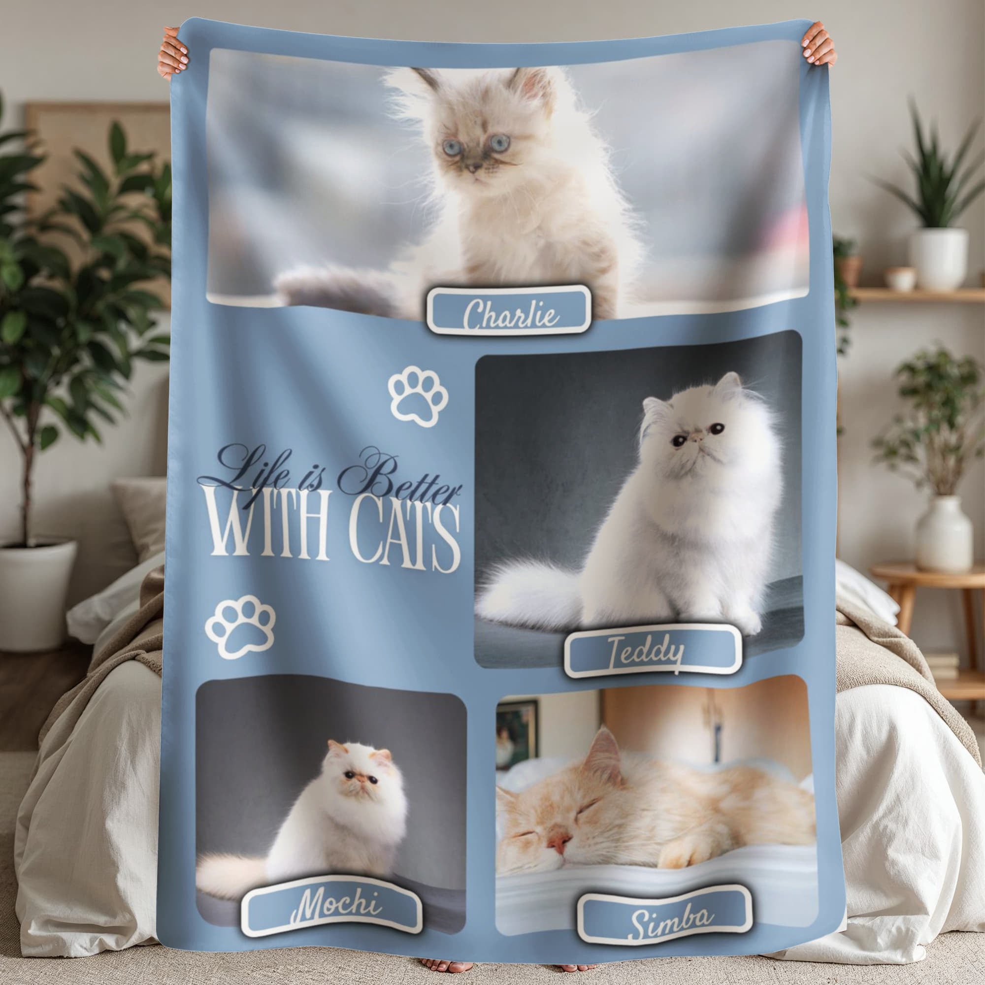 Blanket with images of cats and text 'Life is Better With Cats' held by a person in a room.