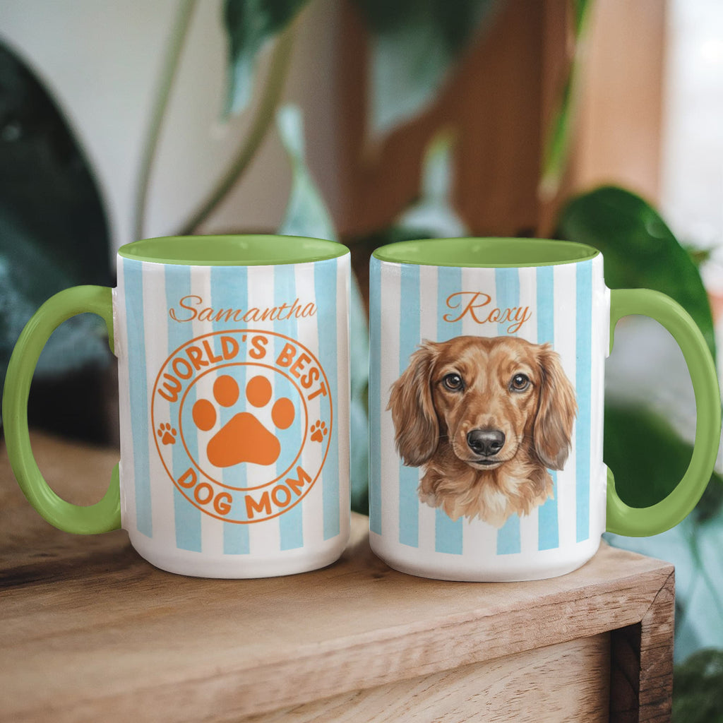 Two mugs with dog-themed designs on a wooden surface.
