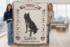 Two people holding a blanket with a Pitbull design and text about the breed. Personalize your woven blanket with your favorite picture of your Pittie with their name.