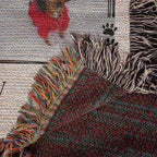 Close-up of a textured rug with colorful fringe and paw print design.
