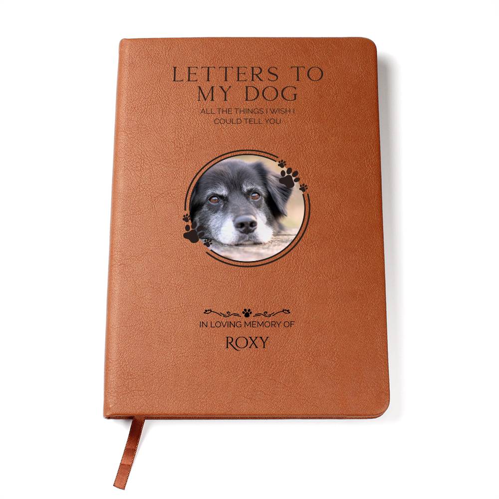 Brown notebook with a dog's face and text on the cover, on a white background