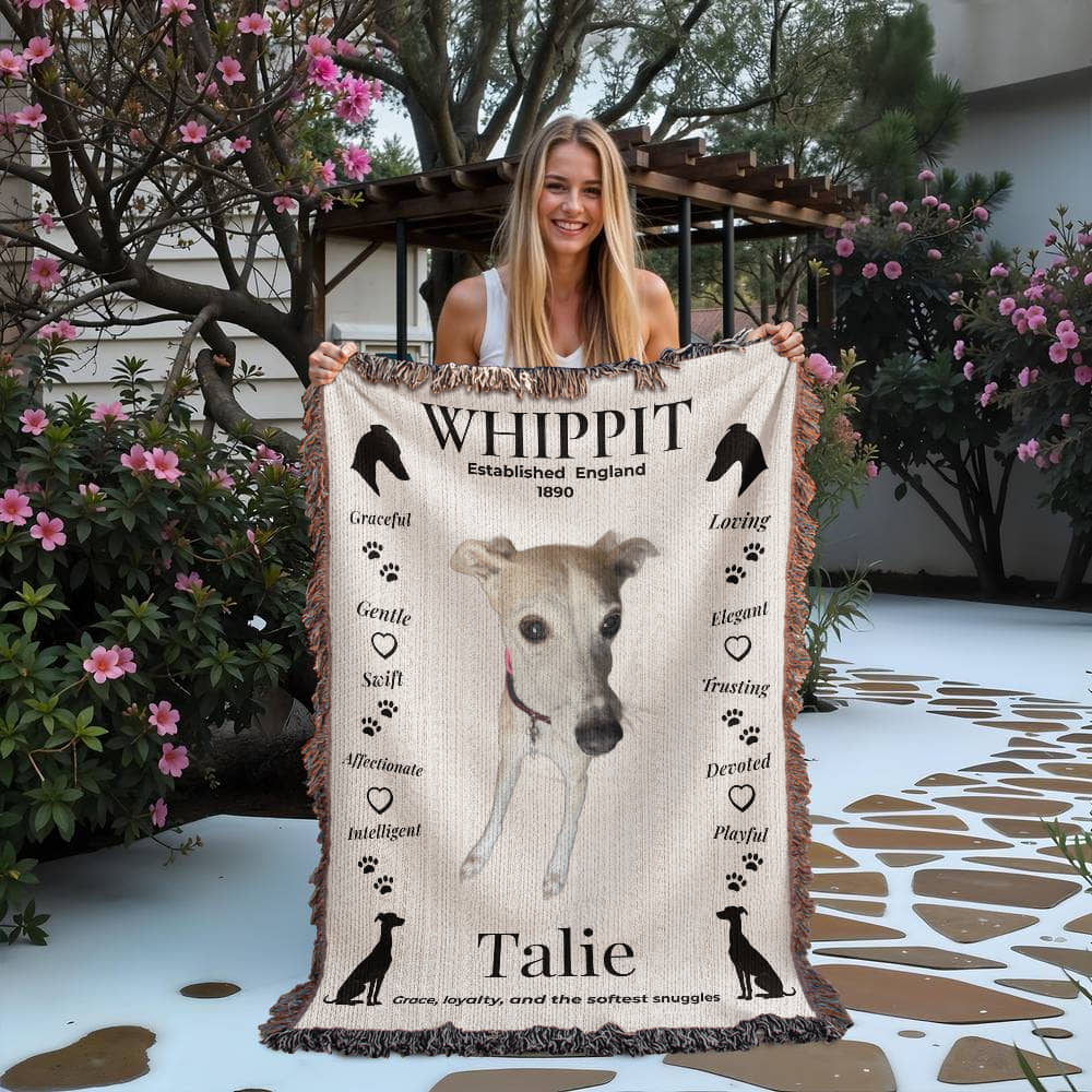 Woman holding a blanket with a whippet design and text outdoors. Personalize your woven blanket with your favorite photo of your Whippit.