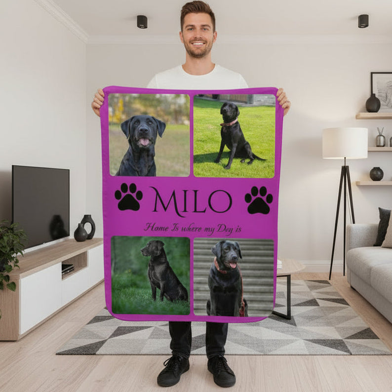 Person holding a purple blanket with dog photos and text in a living room.