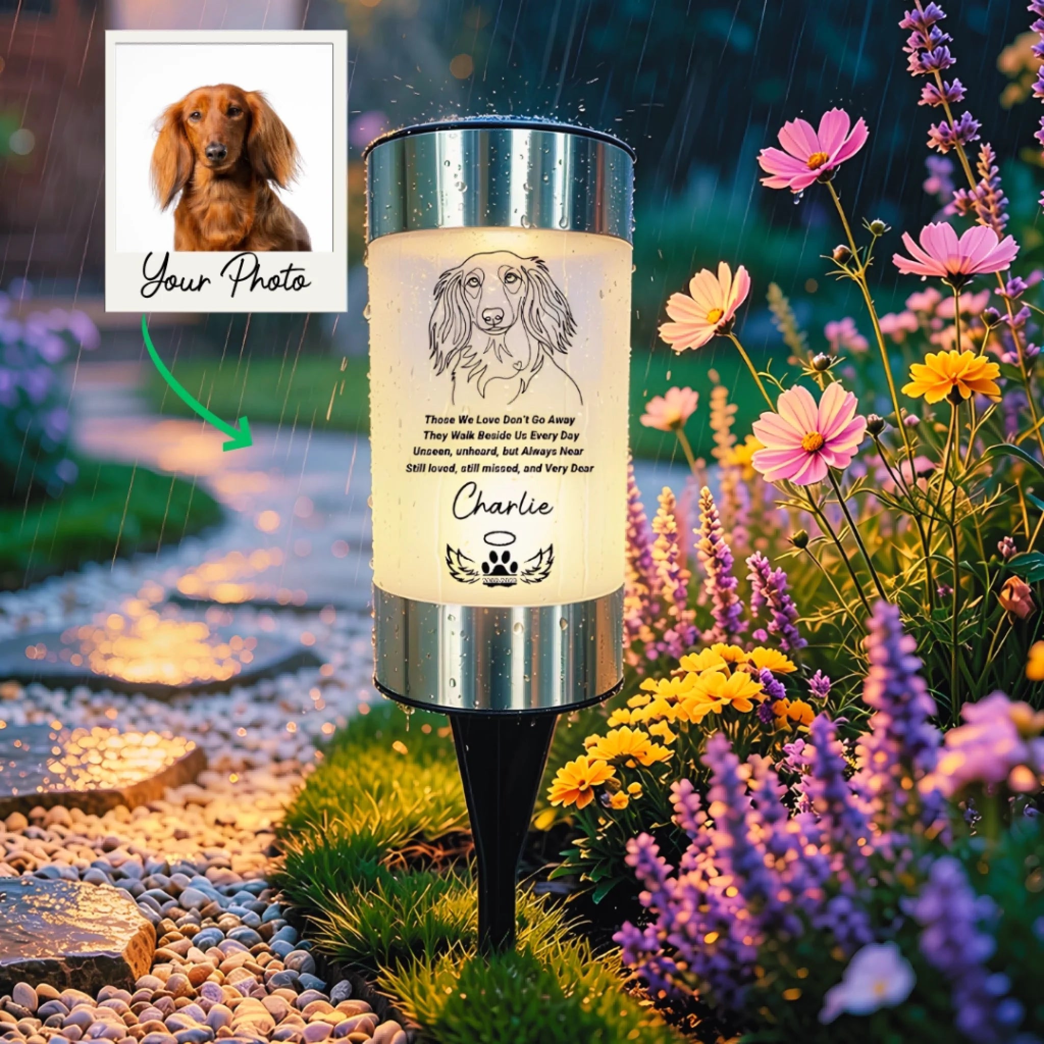 A custom dog memorial garden stake lamp shown outdoors in a garden during rain. The cylindrical lamp features a printed illustration of a dachshund and the text 