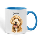 A white ceramic mug with a blue handle and blue interior, featuring a printed portrait of a golden doodle dog and the name 'Cooper' in black script on the front.