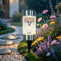 A cylindrical outdoor garden light with a black stake and silver top/bottom, glowing with a warm white light. The front label reads 'Happy Halloween' with a dog in a ghost costume and the name 'Centa'.