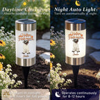A split-screen comparison showing a solar-powered Halloween garden light in daylight and nighttime. The left side, labeled 'Daytime Charging,' shows the light charging in sunlight with flowers and garden foliage around it.