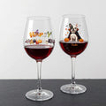Two clear wine glasses filled with red wine, displayed on a dark surface against a light gray background. The left glass has a colorful 'Happy Halloween' decoration, and the right glass is personalized with a cartoon French Bulldog and the name 'Frankie' in gold script.