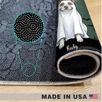 A rolled sheet of black fabric with a white dotted pattern and a printed illustration of a dog in a white ghost costume, shown on a light wood floor. A circular inset highlights the fabric's dotted texture.