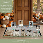 A personalized dog door mat displayed on a front porch, featuring illustrated dogs dressed as pharaohs with the text 'LET'S GET THE DOGS FLIP'. The mat is shown in a seasonal autumn setting with pumpkins and a wooden door, with sample photo inserts and text overlays indicating customization options.