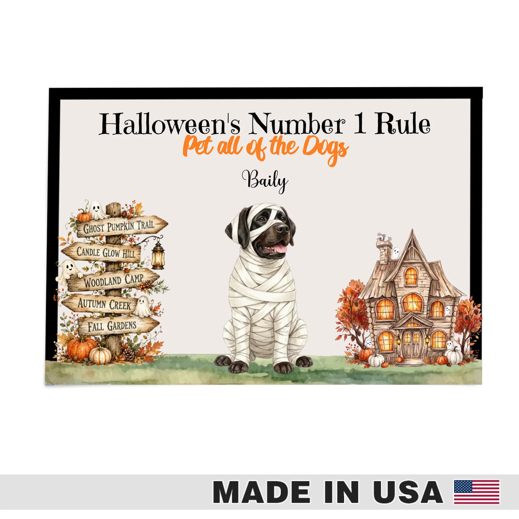 A personalized Halloween-themed plaque or sign featuring the text 'Halloween's Number 1 Rule', 'Pet all of the Dogs', and the name 'Baily'. The design shows a mummy dog in the center, a haunted house on the right, and autumn trail signs on the left, all on a light background with a black border.