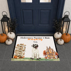 A personalized Halloween doormat displayed in front of a dark blue front door. The mat features a mummy dog, a haunted house, a signpost, and the text 'Halloween's Number 1 Rule For all of the Dogs' followed by the name 'Bebey'.