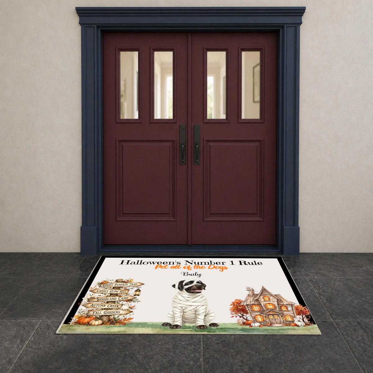 A personalized Halloween doormat featuring a mummled pug, a haunted house, pumpkins, and the text 'Halloween's Number 1 Rule. Get all the treats.