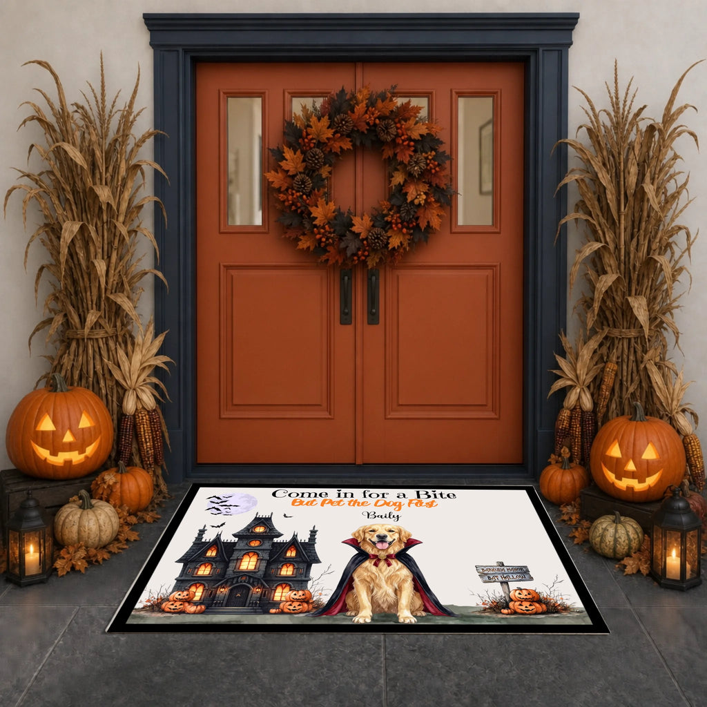 A Halloween-themed rectangular doormat displayed in front of a decorated front door. The mat features a black castle, a vampire in a cape, a golden retriever, and the text 'Come In for a Wife Just for the Fun of You'.