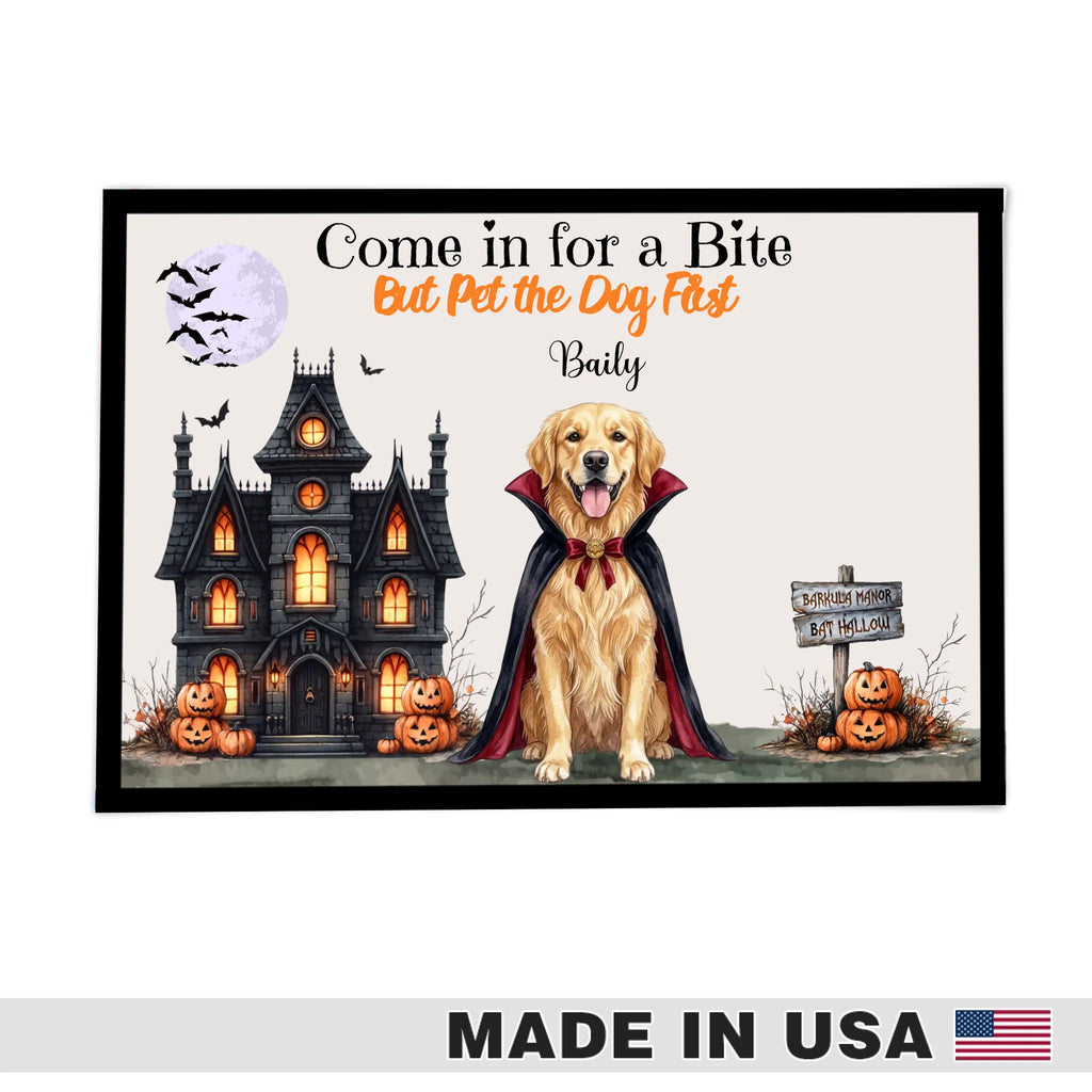A framed Halloween-themed pet poster featuring a golden retriever dog in a vampire cape in front of a haunted house, pumpkins, bats, and a full moon. The text reads 'Come in for a Bite But Pet the Dog First Daily.