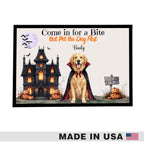 A framed Halloween-themed pet poster featuring a golden retriever dog in a vampire cape in front of a haunted house, pumpkins, bats, and a full moon. The text reads 'Come in for a Bite But Pet the Dog First Daily.