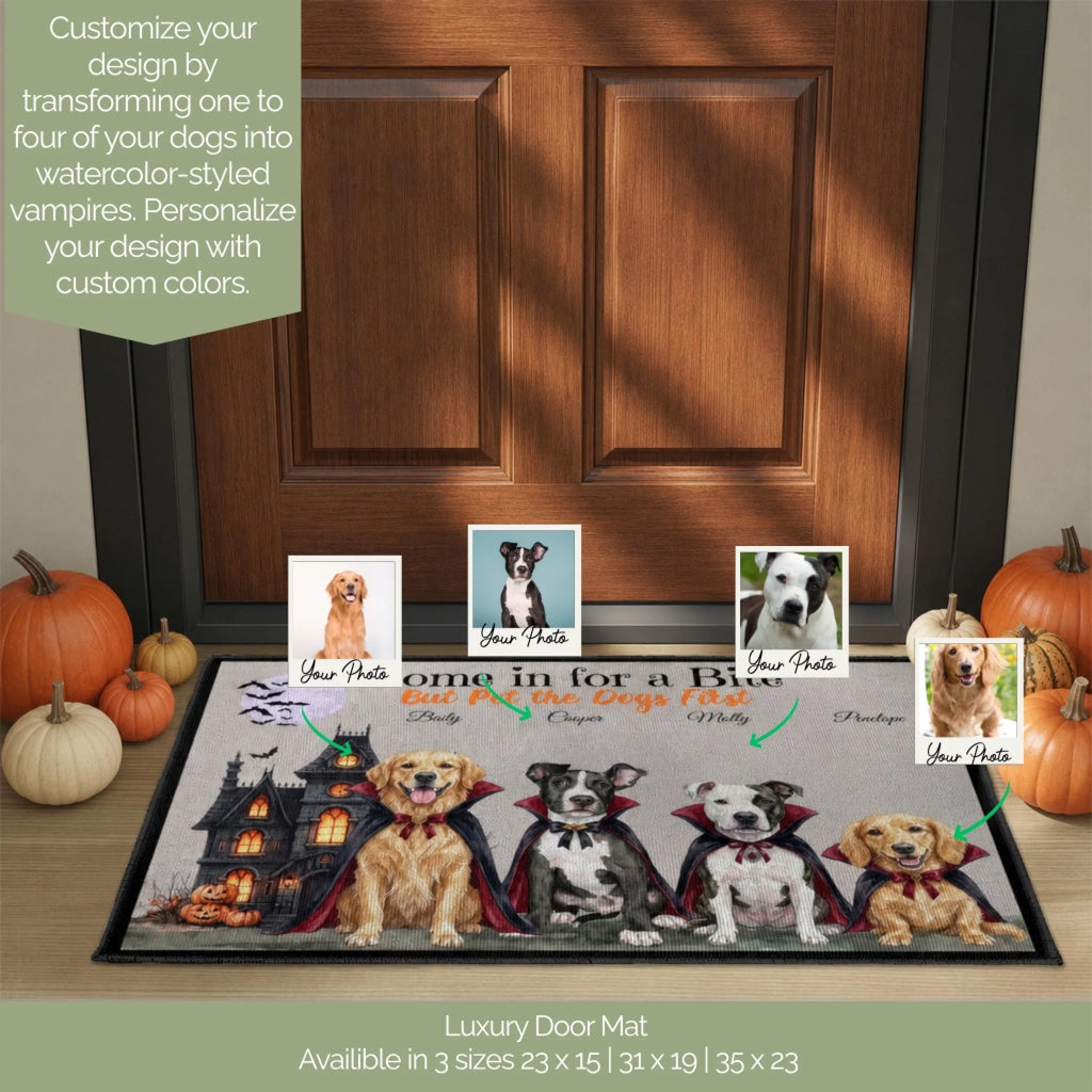 A personalized dog door mat displayed in front of a wooden front door, featuring four dressed-up vampire dogs with editable photo placeholders. The mat includes Halloween-themed graphics like a haunted house and bats.