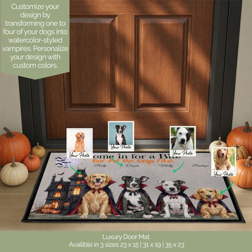 A personalized dog door mat displayed in front of a wooden front door, featuring four dressed-up vampire dogs with editable photo placeholders. The mat includes Halloween-themed graphics like a haunted house and bats.