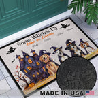 A Halloween-themed doormat with illustrated dogs in witch hats, a haunted house, bats, and the text 'Some Witches Fly Mine do Enemies' displayed on a tiled entryway floor in front of a teal door. A circular inset shows a close-up of the black dotted pattern, and a 'MADE IN USA' badge appears at the bottom.