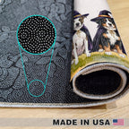 A rolled-up black yoga mat with a white dotted pattern and a printed illustration of two dogs dressed as witches, shown on a light wood floor. A circular zoom-in highlights the detailed dot pattern.