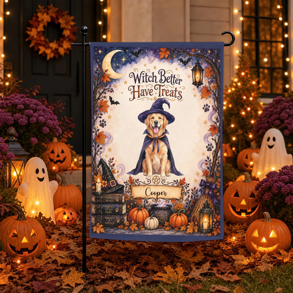 A Halloween-themed garden flag displayed on a black flagpole outdoors in a decorated yard. The flag features an illustration of a golden retriever dressed as a witch with the text 'Witch Better Have Treats' and the name 'Cooper' on a banner.
