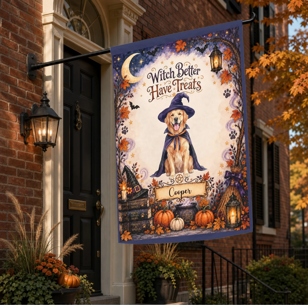 A Halloween-themed vertical garden flag hanging from a black metal bracket on a brick house porch. The flag features a golden retriever dressed as a witch with the text 'Witch Better Have Treats' and the name 'Cooper' on a banner.