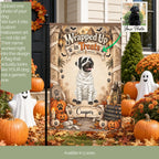 A Halloween-themed garden flag displayed outdoors in a decorated yard with pumpkins, autumn leaves, and ghost decorations. The flag features a mummy-wrapped dog with the text 'Wrapped Up in Treats' and the name 'Cooper' at the bottom.