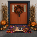 A Halloween-themed doormat featuring a witch, cat, and pumpkins with the text 'Witch Better Have Treats' and 'Barley and Oliver', placed in front of a decorated double door with pumpkins, corn stalks, and a wreath.
