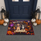 A rectangular Halloween-themed doormat displayed in front of a dark blue front door. The mat features two dogs dressed as witches, pumpkins, cauldron, bats, and autumn leaves, with the text 'Witch Better Have Treats' and personalized names 'Bailey and Oliver'.