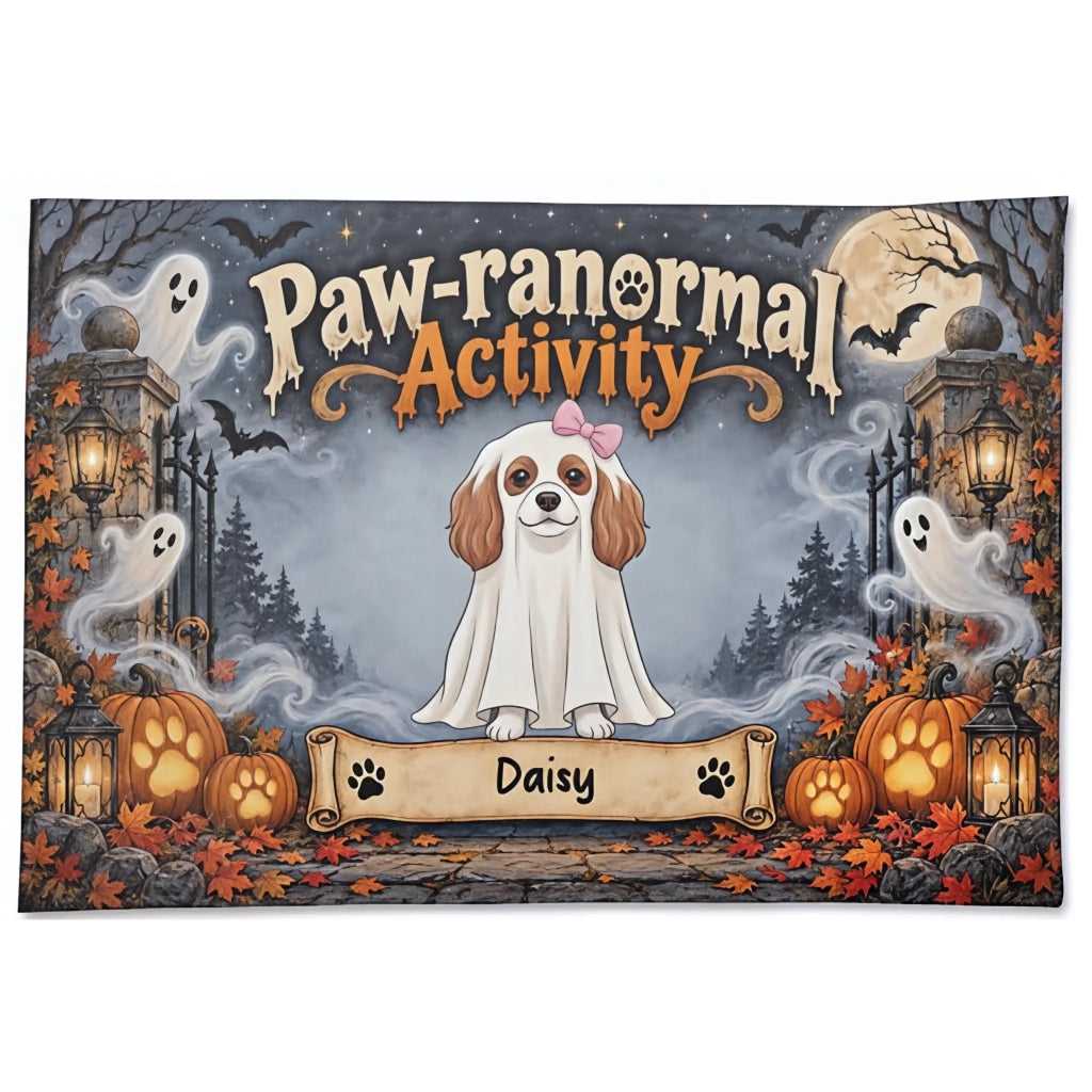 A square Halloween-themed decorative mat or doormat featuring a cartoon dog in a white ghost costume with the text 'Paw-ranormal Activity' above and a personalized banner reading 'Daisy' below. The scene includes pumpkins, lanterns, ghosts, bats, trees, and a full moon on a dark gray background.