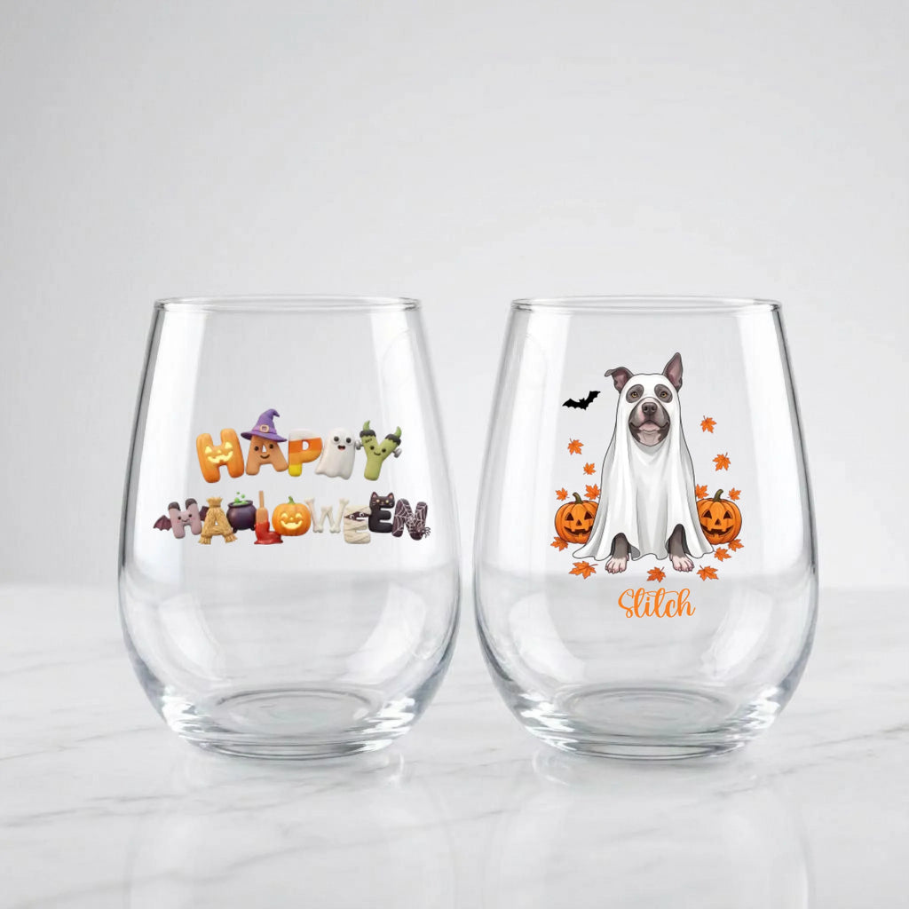 Two personalized Halloween stemless wine glasses on marble, one with 'Happy Halloween' lettering, one with a ghost-costume dog with pumpkins and pet name