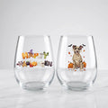 Two personalized Halloween stemless wine glasses on marble, one with 'Happy Halloween' lettering, one with a mummy-costume dog with pumpkins and pet name
