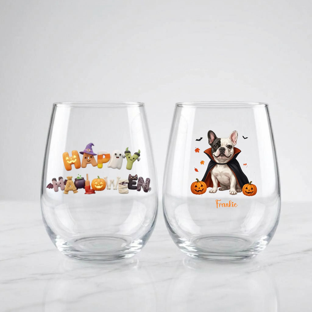 Two personalized Halloween stemless wine glasses on marble, one with 'Happy Halloween' lettering, one with a vampire-costume dog with pumpkins and pet name